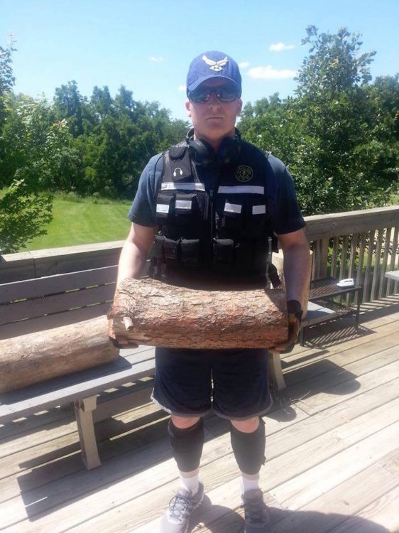 man in the us air force holding a log