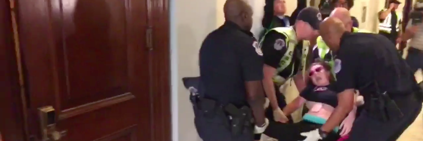 ADAPT Disability Advocates Protest Medicaid Cuts in DC woman being taken out of her wheelchair