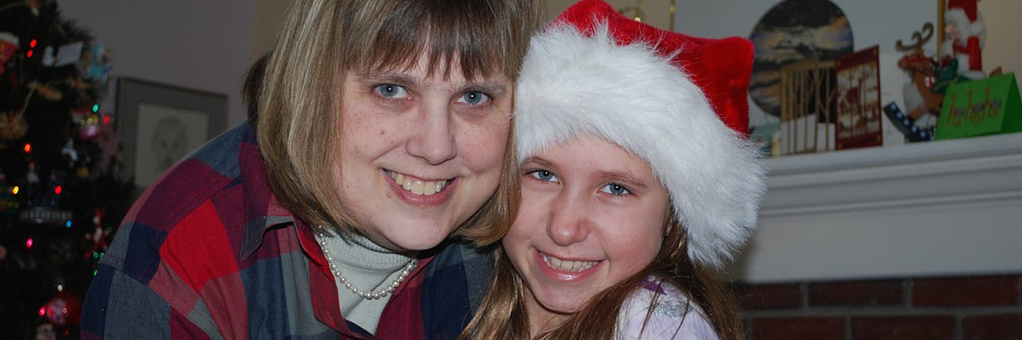 Living With a Clotting Disorder and Focusing on the Positive The author with her niece, wearing a Santa hat
