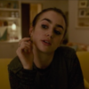 lily collins looking toward the camera
