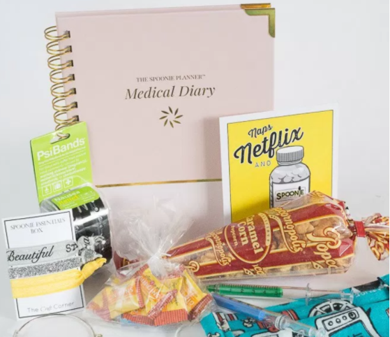 spoonie essentials box with diary, popcorn, and braccelets