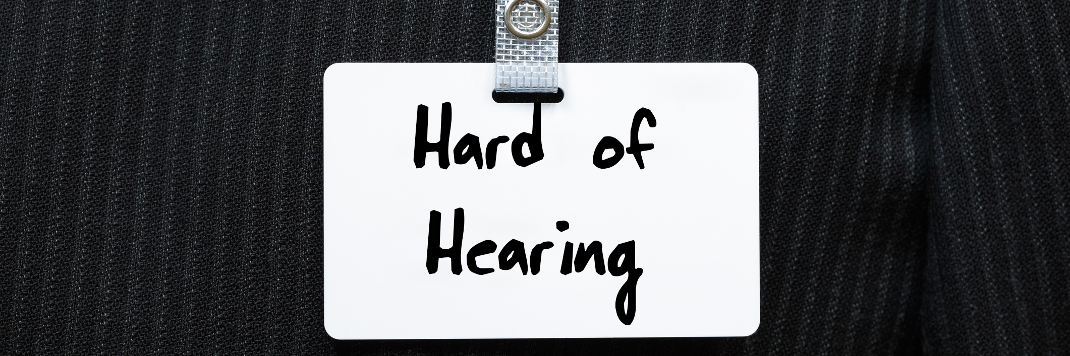 How Labels Can Create Greater Understanding Surrounding Disability Tag on suit that says "hard of hearing."