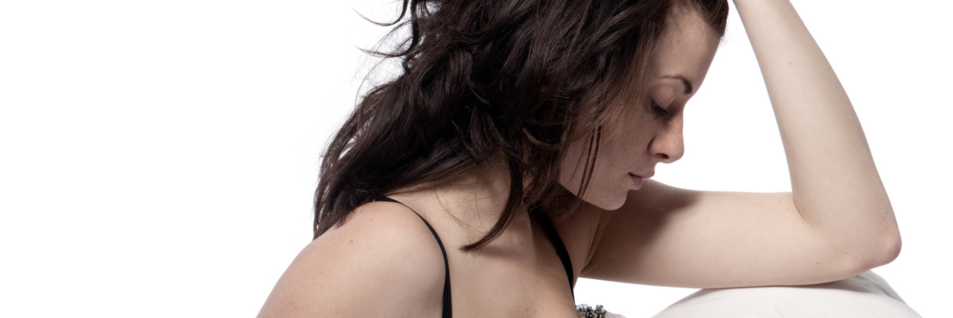 A Week in My Life With Anxiety young woman in bed looking stressed or anxious