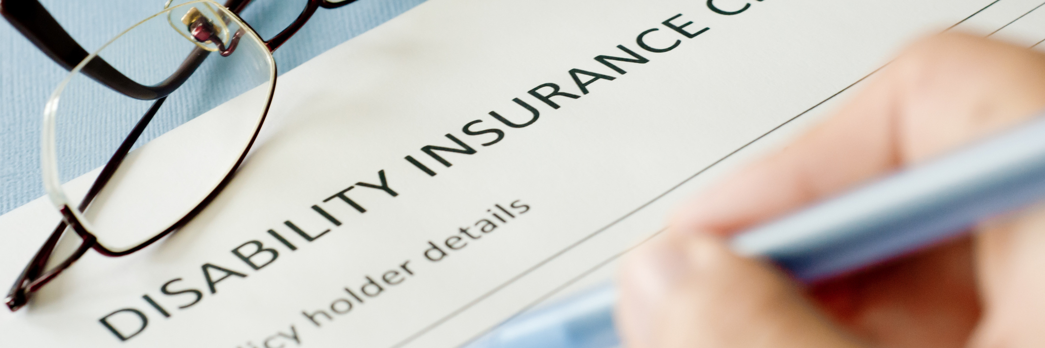 Trigeminal Neuralgia: Questions Disability Insurers Should Be Asking person filling out a disability insurance form