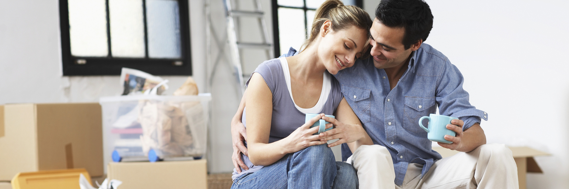 How to Support a Loved One Who Has Endometriosis a couple sitting together in their home hugging and drinking tea