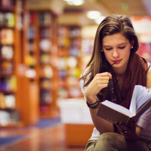 A college student studying in the library.