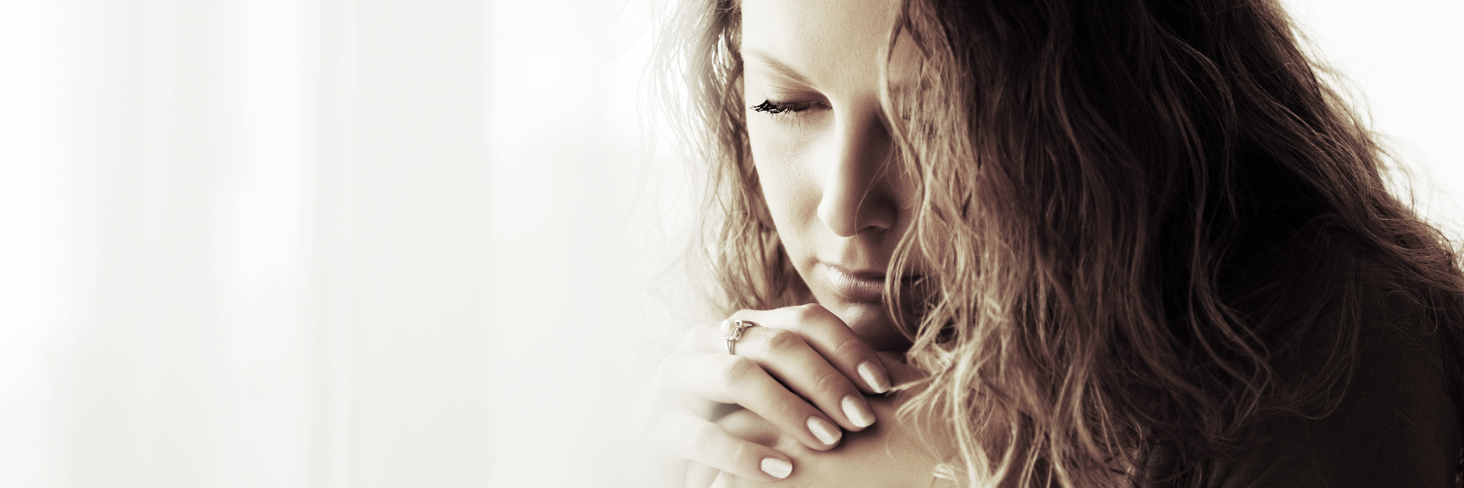 How the Psychiatric Hospital Helped Me Find a Reason to Live sad woman with curly hair looking down