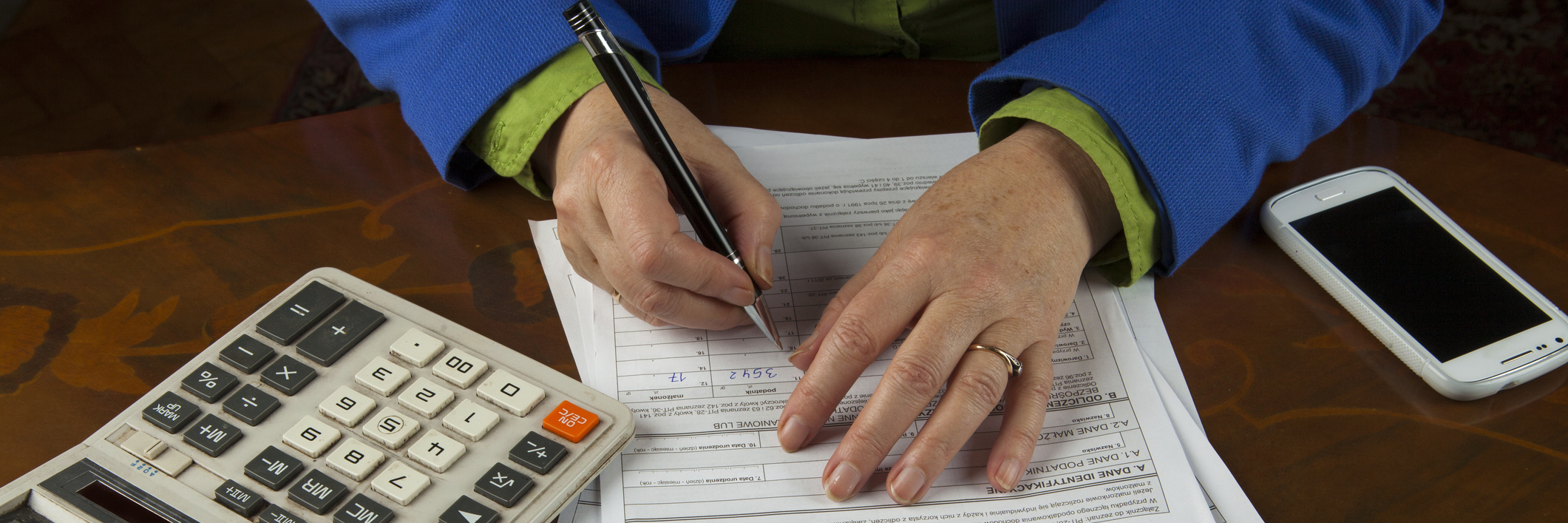 Woman filling out paperwork.