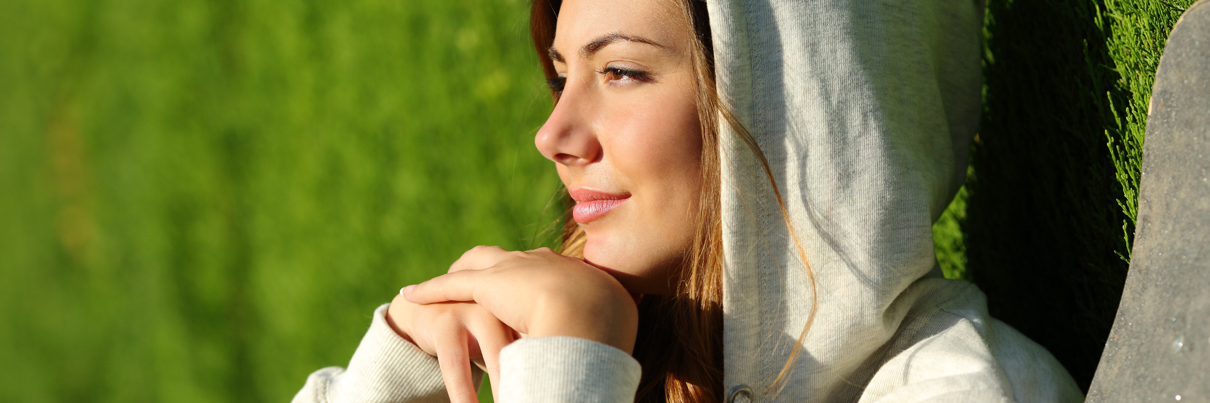 Self-Harm Recovery and Making It Through One Day young woman staring out over sunset looking pensive