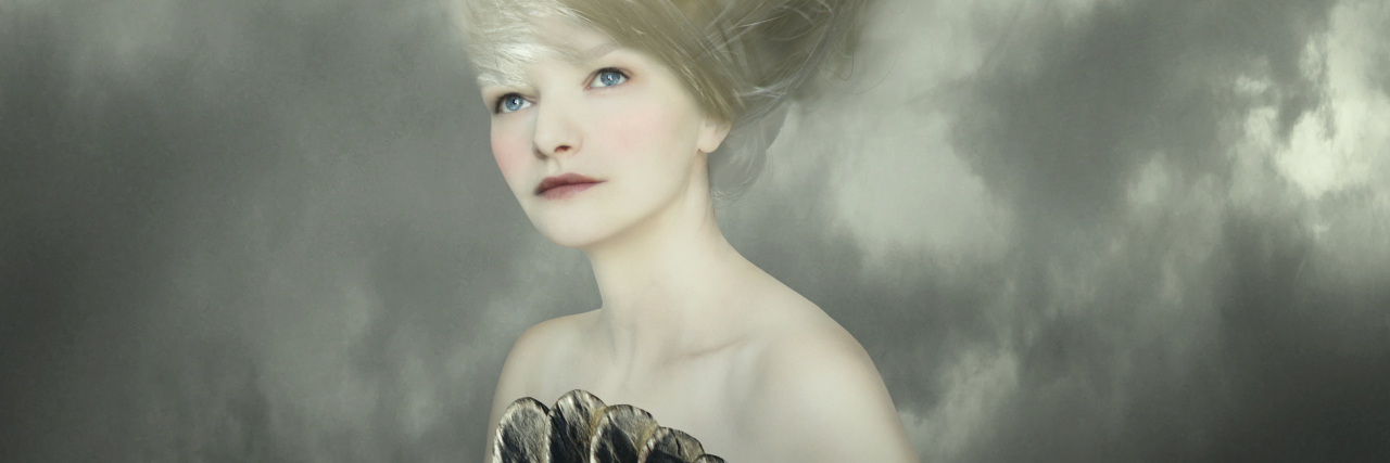 After a Mental Health Crisis, What Happens Next? Sophisticated and artistic portrait of a beautiful female model with a white dove on a branch in the very long blond hair