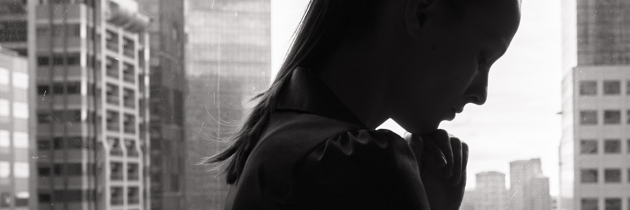 What People Don’t Understand About Self-Harm Behaviors woman in front of a city skyline