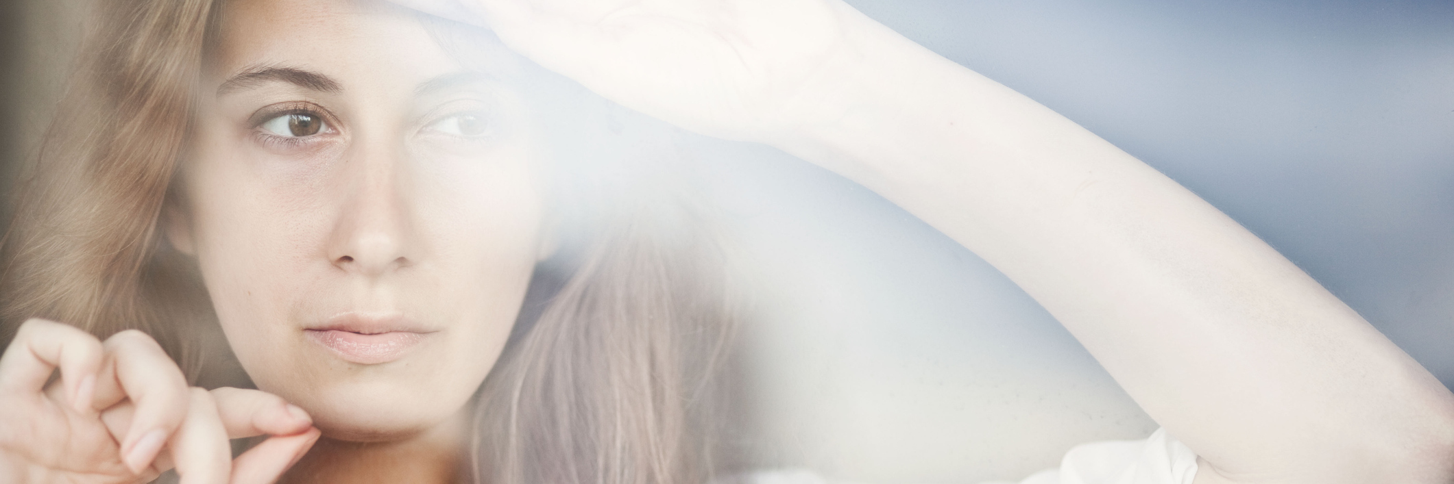 Having Unpredictable Future With Epilepsy, Grand Mal Seizures woman leaning against a window looking nervous