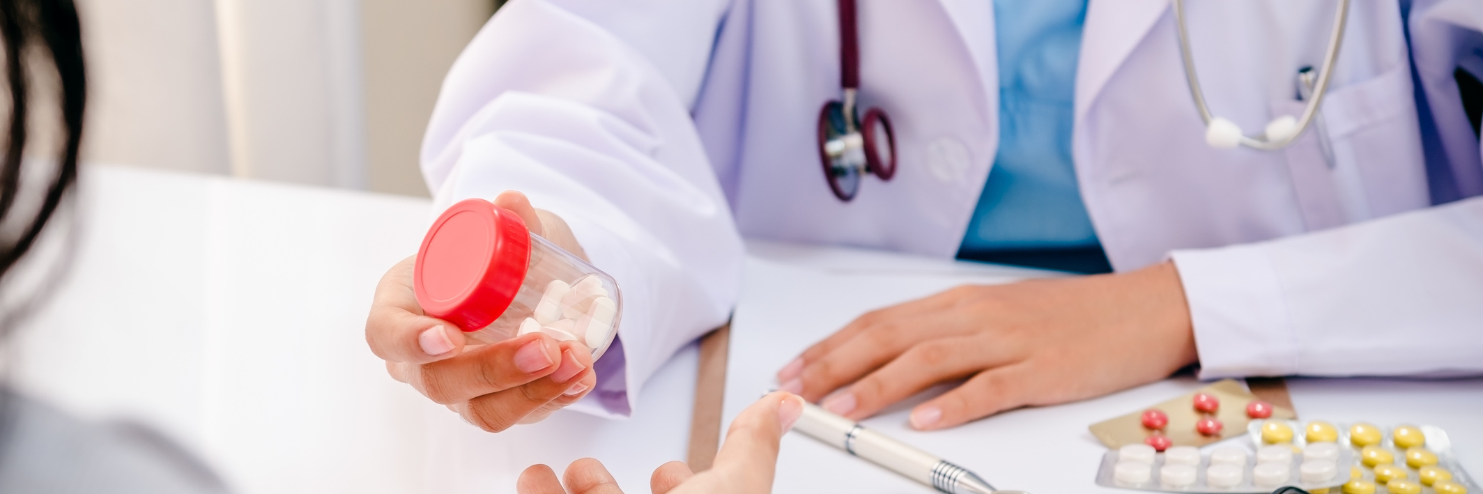 Asking Doctor Not to Treat Patients With Chronic Pain as Drug-Seekers doctor handing bottle of medication to a patient
