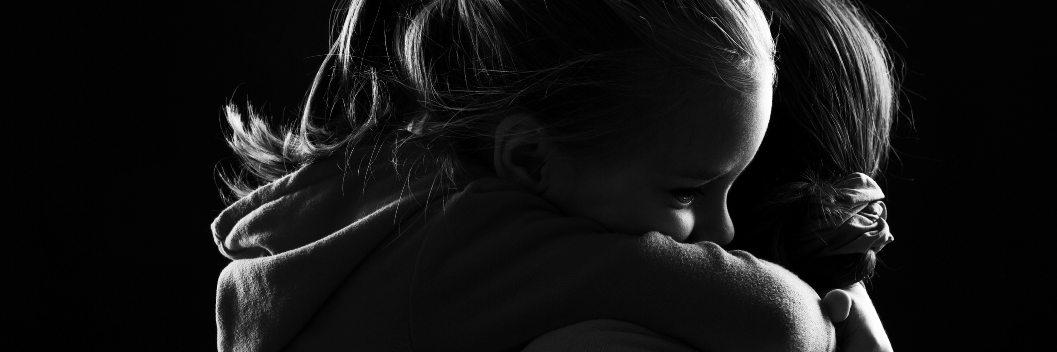 When Depression Is an Unwelcome Houseguest: A Poem Black and white image of a little girl hugging her mother