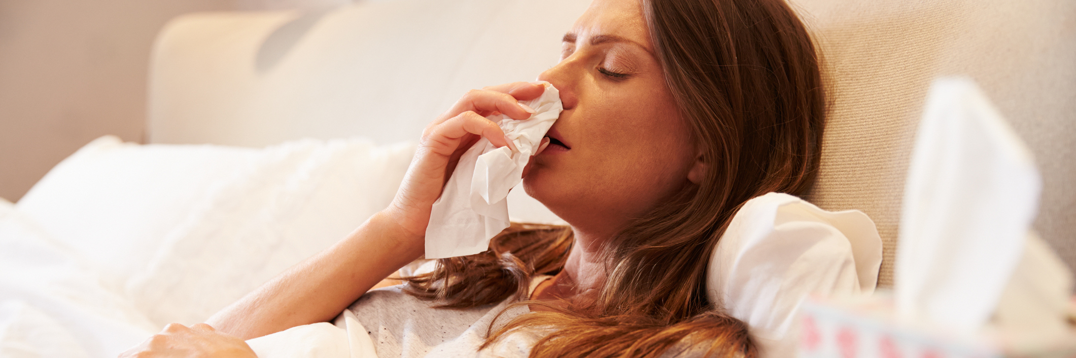 Hypothyroidism: Getting a Cold or the Flu With Chronic Illness woman in bed blowing her nose