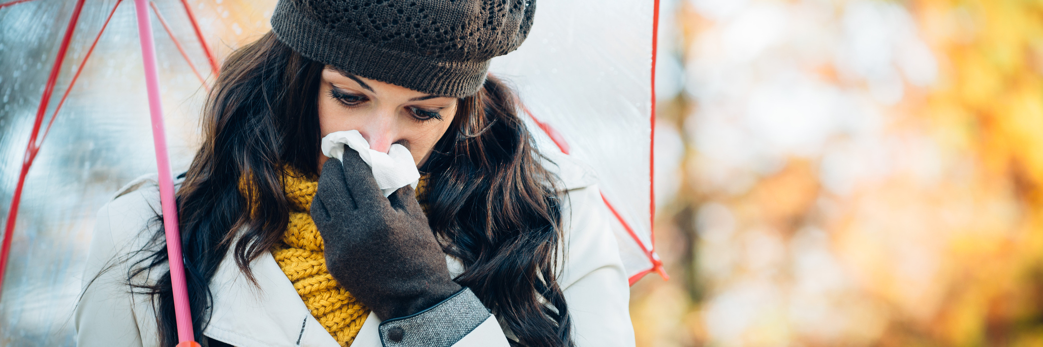 Lesser-Known Symptoms of Postpartum Depression young woman in autumn with tissue, scarf and umbrella