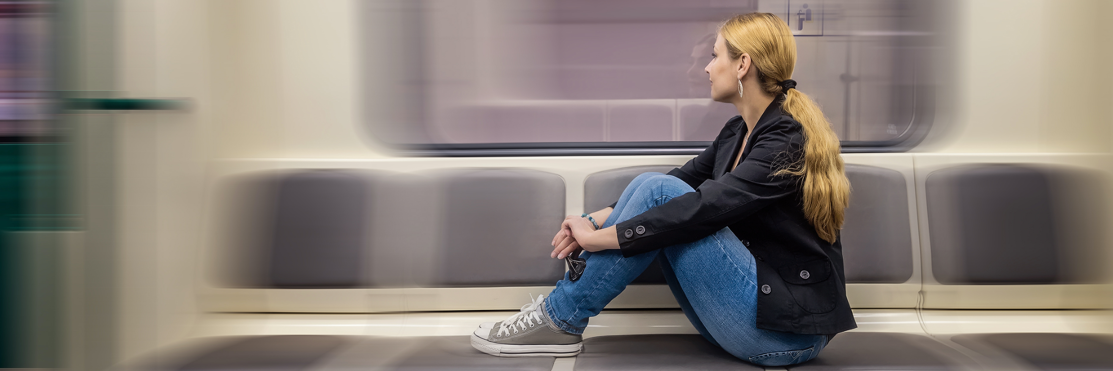 When I Realized My 'Body Quirks' Were Symptoms of a Chronic Illness A blonde woman sitting in subway train and looking at window.