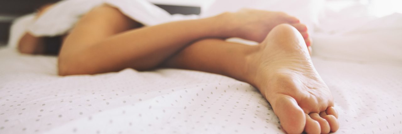 When the Waves of Depression Make You Exhausted Legs of a woman lying in bed