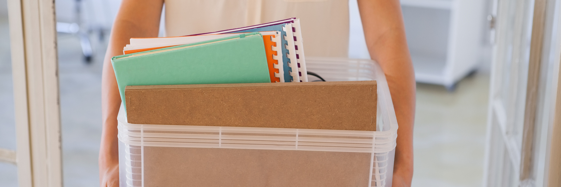 Losing Jobs, Getting Fired Because of Irritable Bowel Syndrome (IBS) woman holding a box of her things after being let go from a job