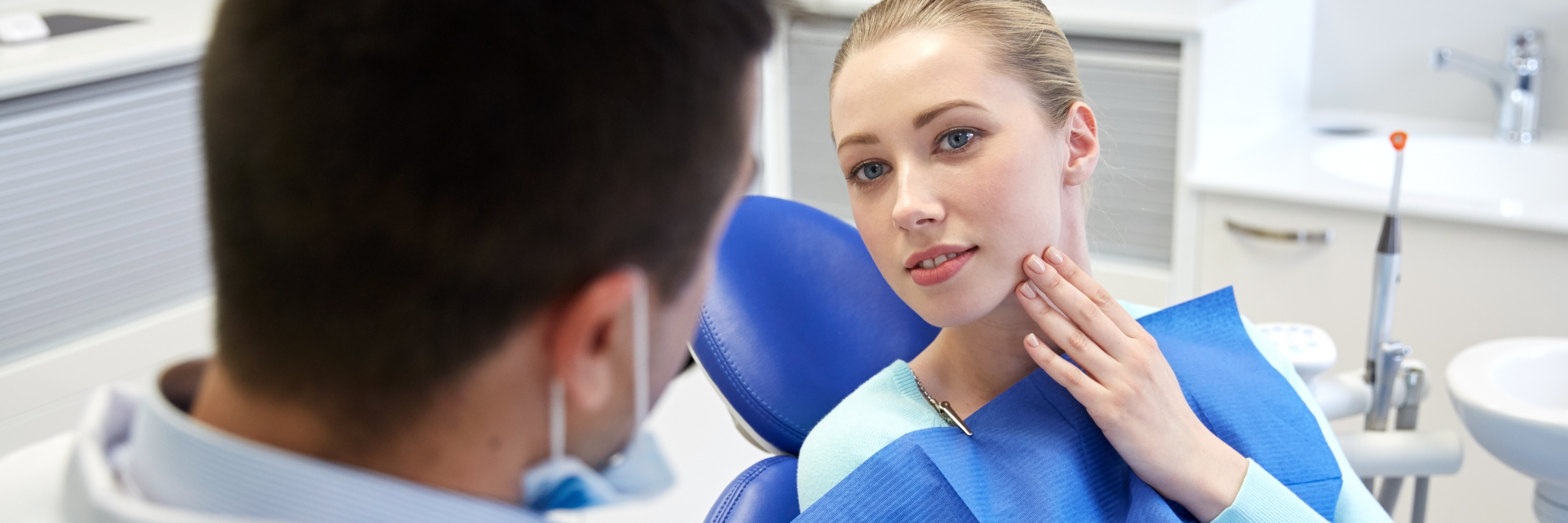 When Depression Makes You Avoid the Important Things young blonde woman at male dentist pointing to side of face