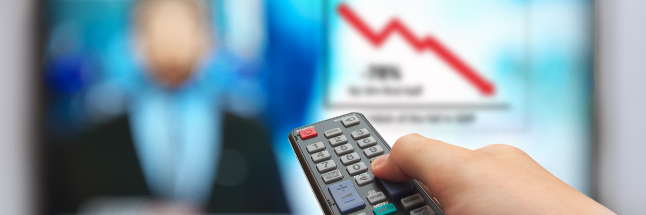 Managing Anxiety and Depression in the Wake of Terrorist Attack News man hand switches TV channels. Nature. Abstract. remote control in hand and TV