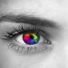 black and white photo of a woman's face with her eyes colored rainbow