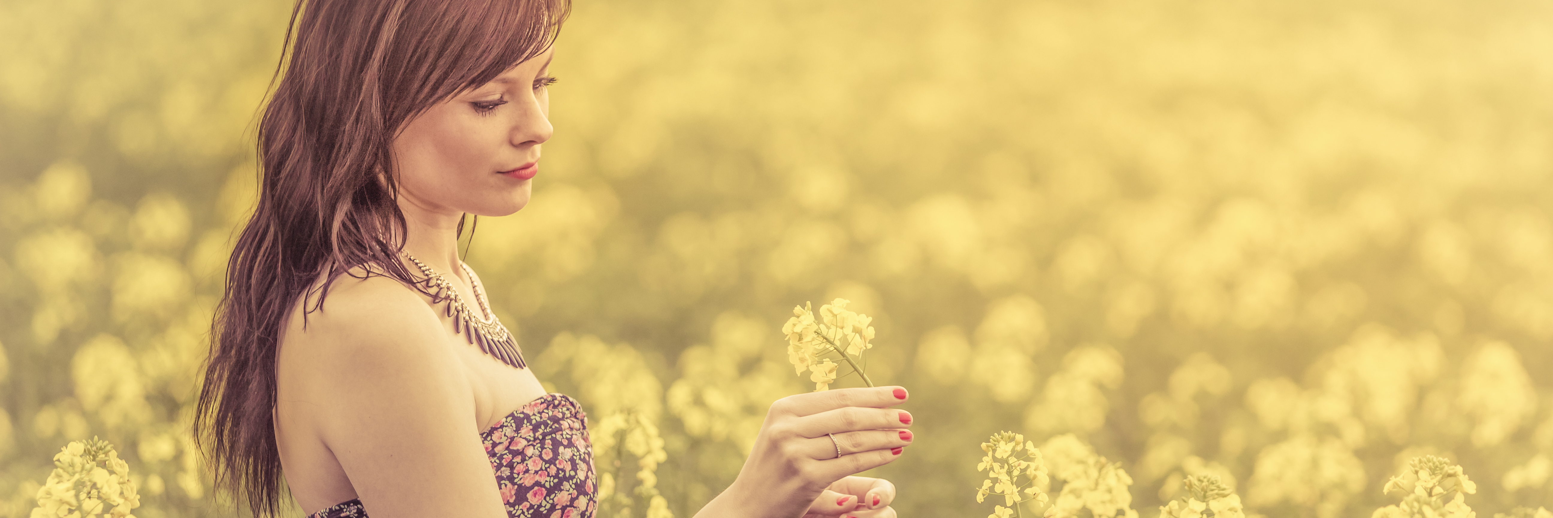 Caring Deeply for Everything Except Yourself young woman in field of yellow flowers and summer sun