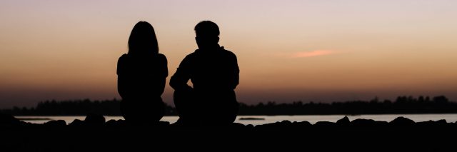 silhouette of man and woman against sunset