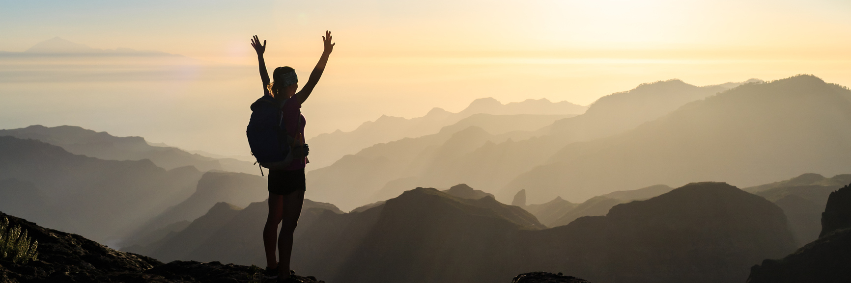 Hashimoto's, Gastroparesis, Dysautonomia: Sharing Burden of Illnesses woman standing on the top of a mountain at sunrise with her arms outstretched
