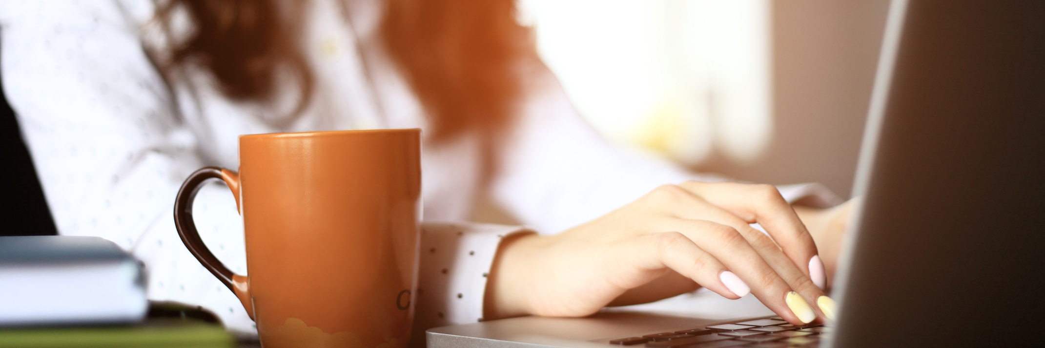 No Longer Hiding My Fibromyalgia at Work woman typing on laptop