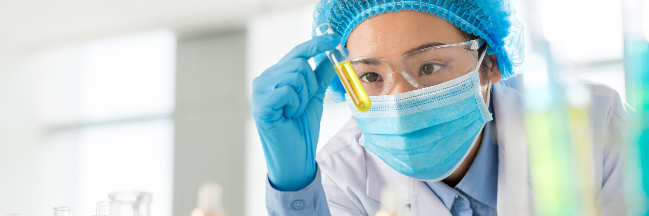 scientist looking at test tubes doing research