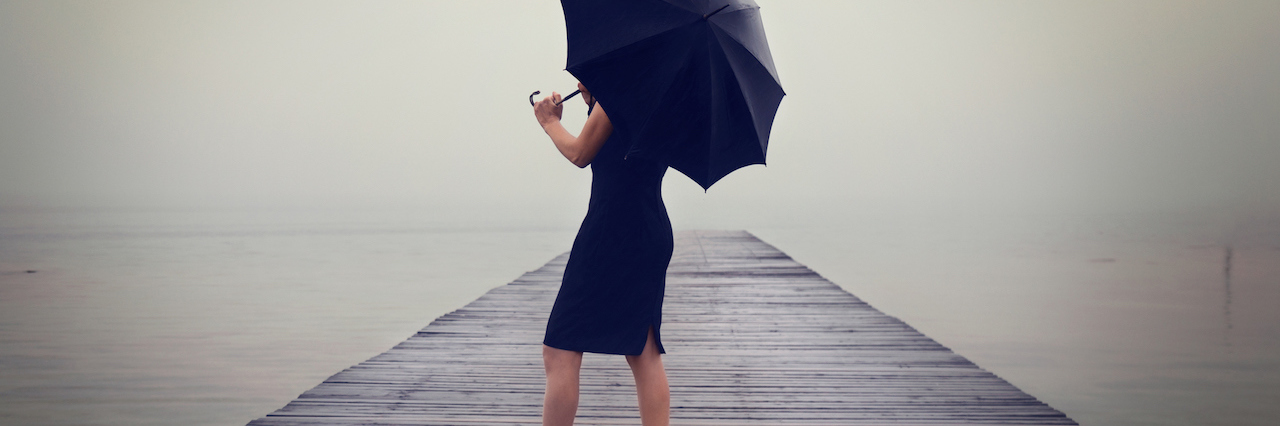 A woman with a black umbrella