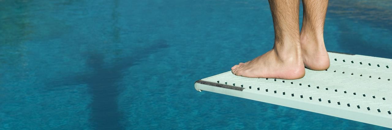 Why I Disagree When People With Anxiety Are Told To ‘Be Brave’ A man on a diving board