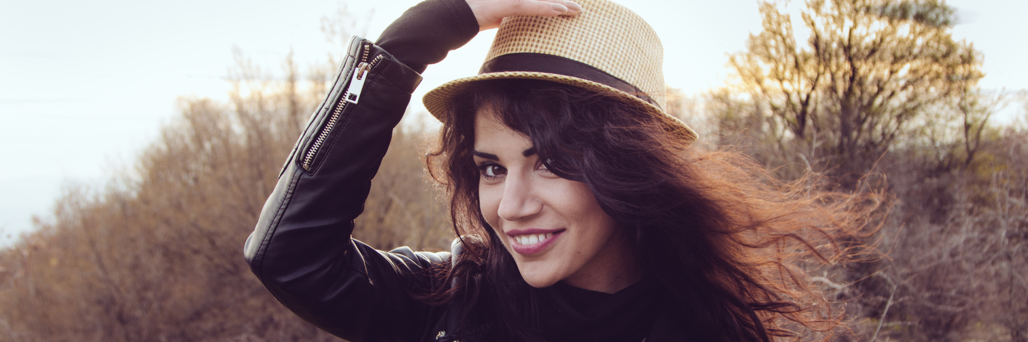 I Have Chronic Pain, but I'm Still a Badass A brunette woman wearing a hat outdoors.