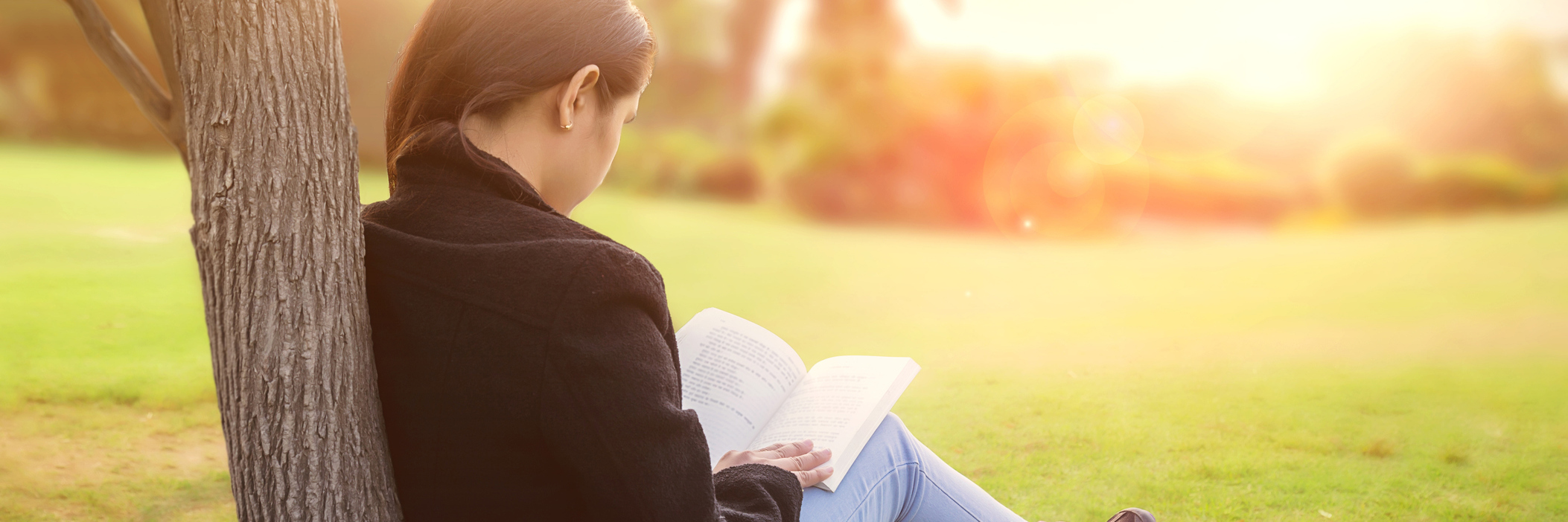 Why You Shouldn't Compare Someone to Who They Were Before Illness woman sitting outside leaning against a tree and reading