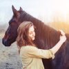 A woman hugging a horse
