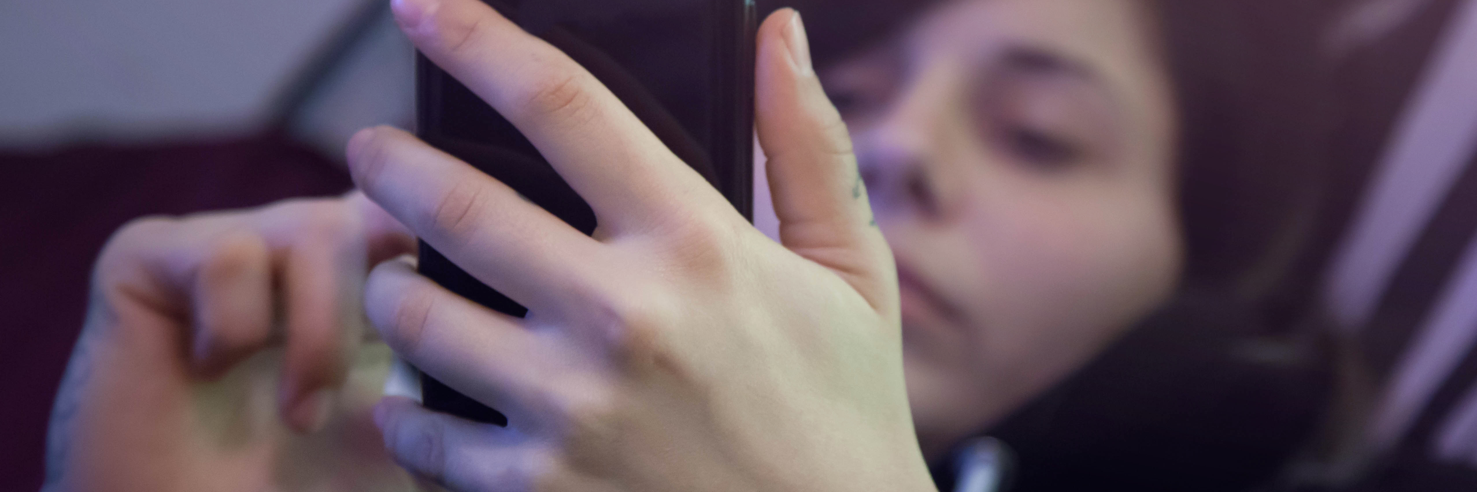 The Message That Helped Me in My Darkest Moment young woman lying in bed using smartphone