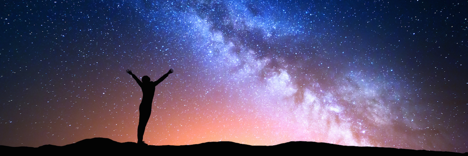 How Stuttering Changed My World Beautifully Illustration of colorful night sky with Milky Way pictured and a silhouette of a woman standing underneath it with arms raised