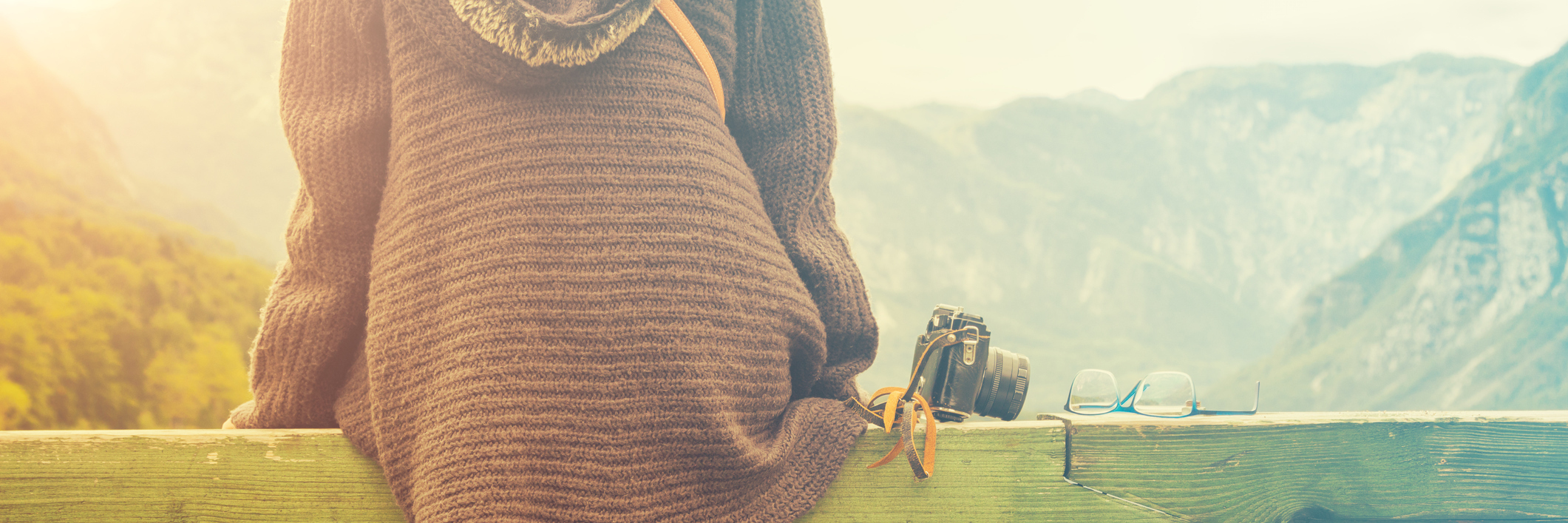 Struggling to Accept Diagnosis With Ménière's Disease woman sitting on a wooden railing next to a lake