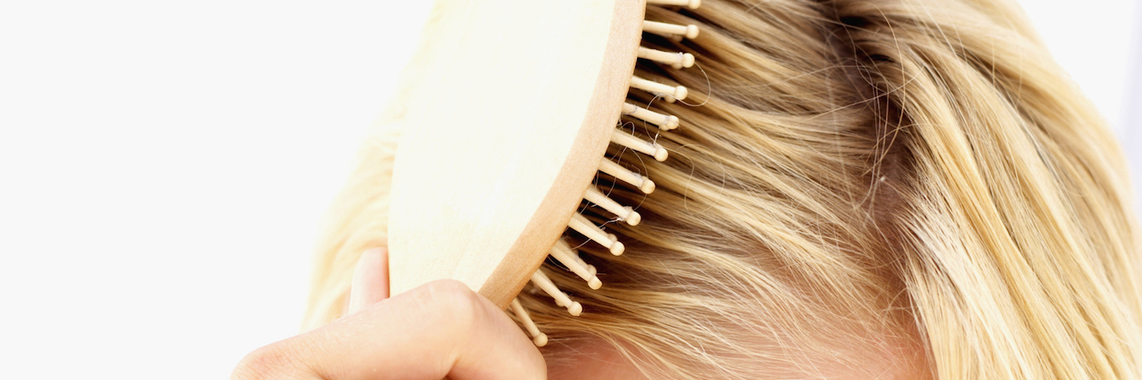 The One Small Victory I Celebrate Over Depression woman brushing her hair