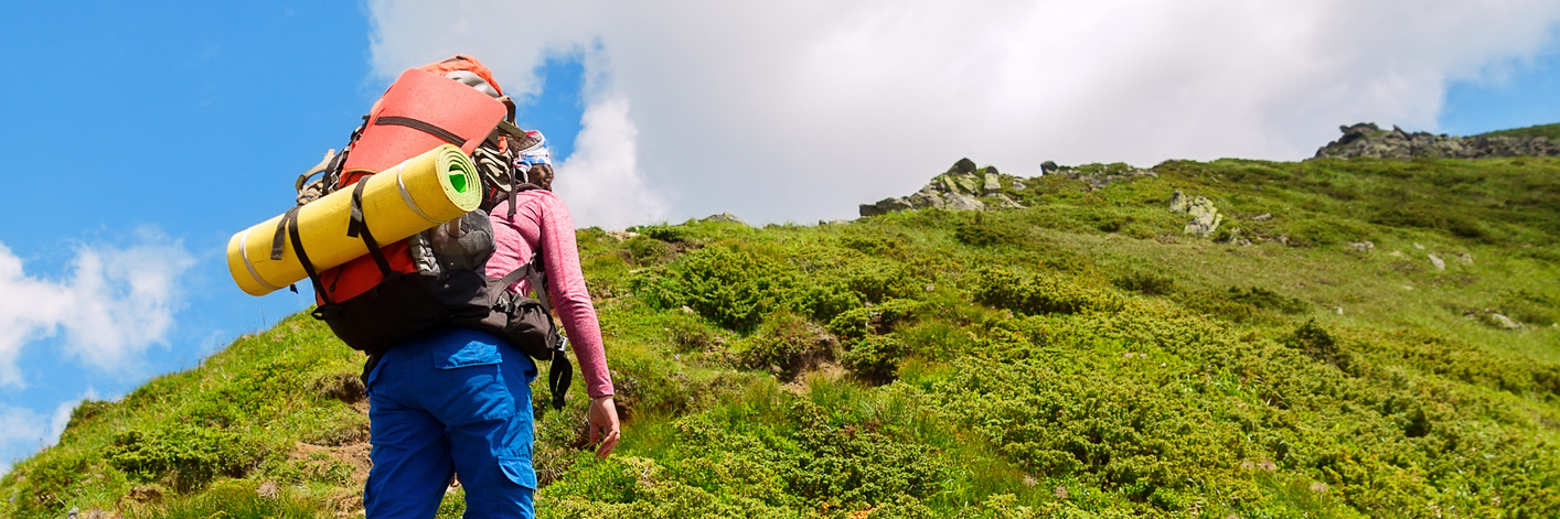 Learning to Accept My Lupus and Chronic Conditions woman hiking up a hill at a steep incline
