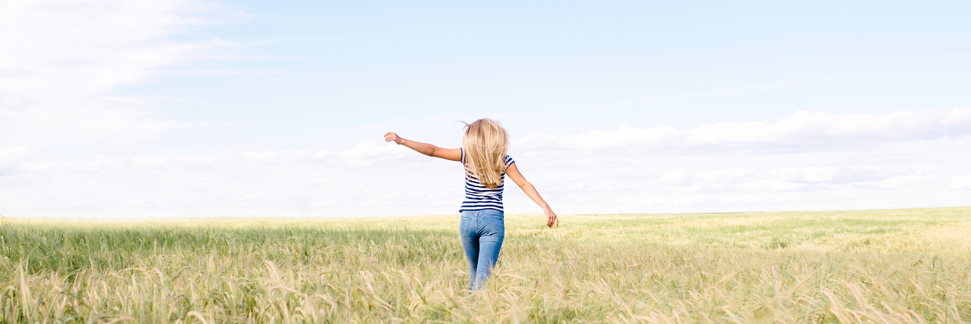 What Does It Mean to Be High-Functioning, and Does It Matter? young blonde woman with arms outstretched in field