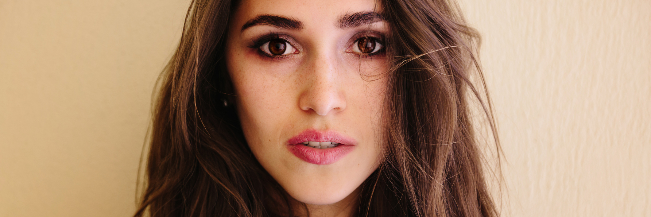 The Insecurities of Living With Psychogenic Non-Epileptic Seizures Woman with a serious look on her face.