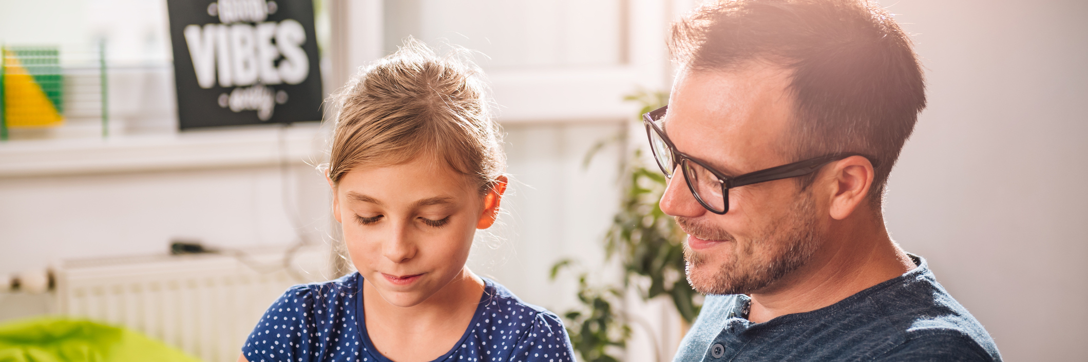 Father helping daughter with homework.