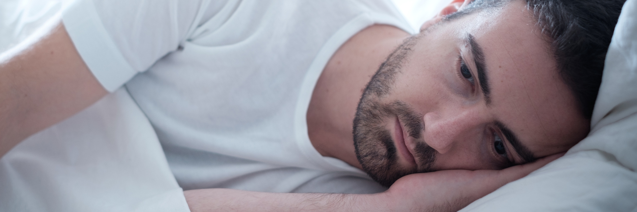 How Borderline Personality Disorder Complicates My Insomnia depressed man lying in bed wide awake