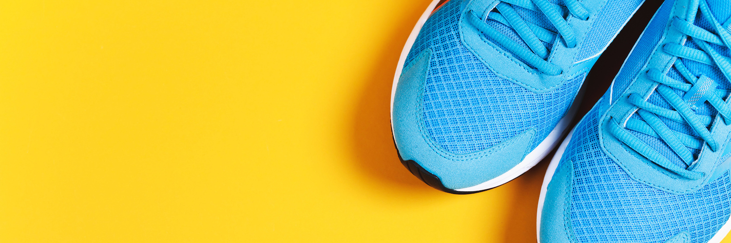 Blue sneakers on yellow background
