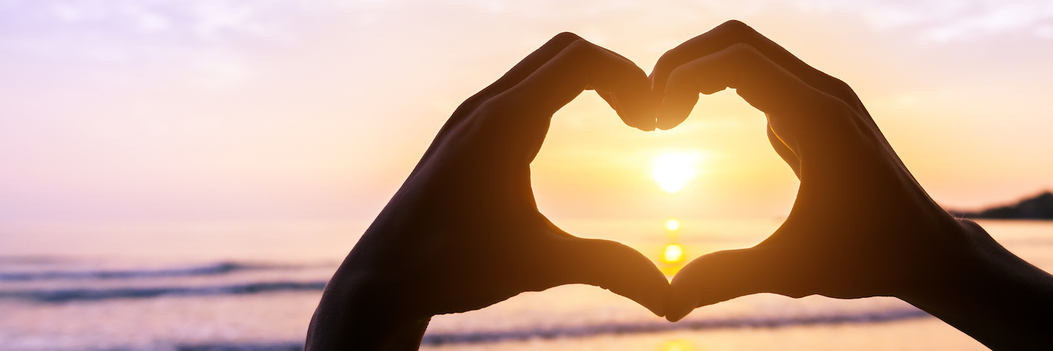 'On a Scale From 1 to 10’: Cancer and Rating How I’m Feeling Silhouette of hands making heart shape on the beach with sun and sunset in the background