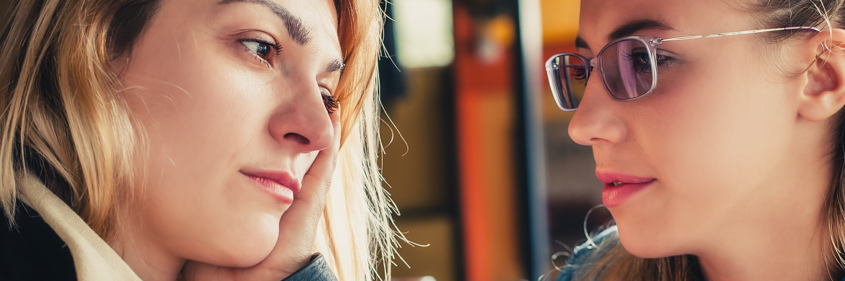 Why I Tell My Story About My Mental Illness two young women talking in restaurant serious conversation looking sad