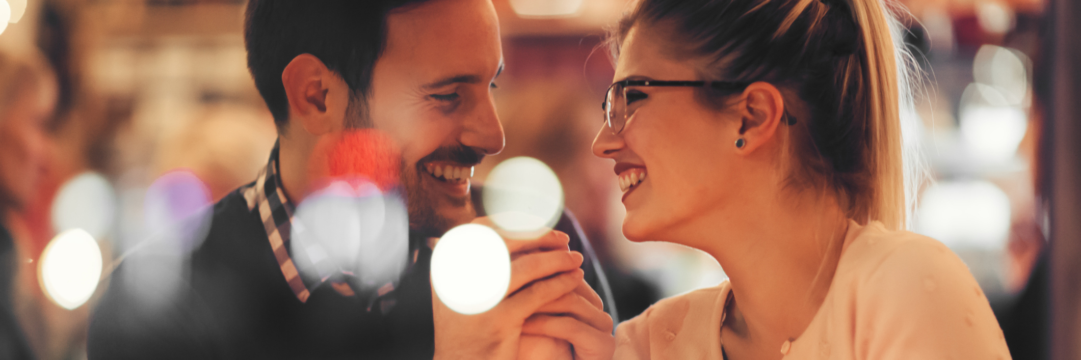 Why You Shouldn't Be Afraid to Date With a Chronic Illness man and woman laughing together in a bar