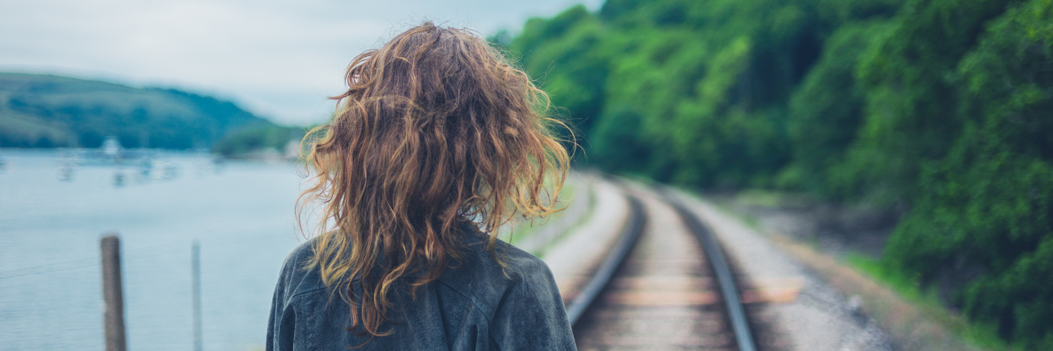 Why I No Longer Want to Define Myself by My BPD young woman walking along railroad tracks